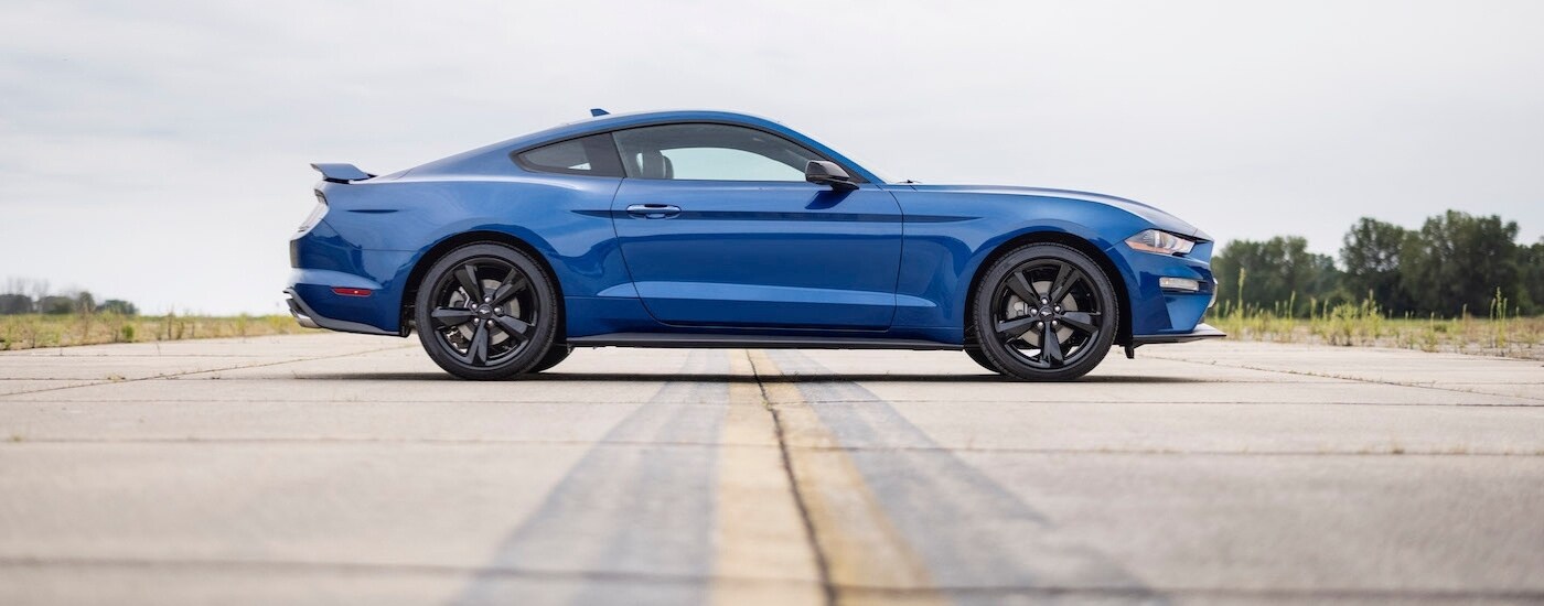 A blue 2022 Ford Mustang from the side.