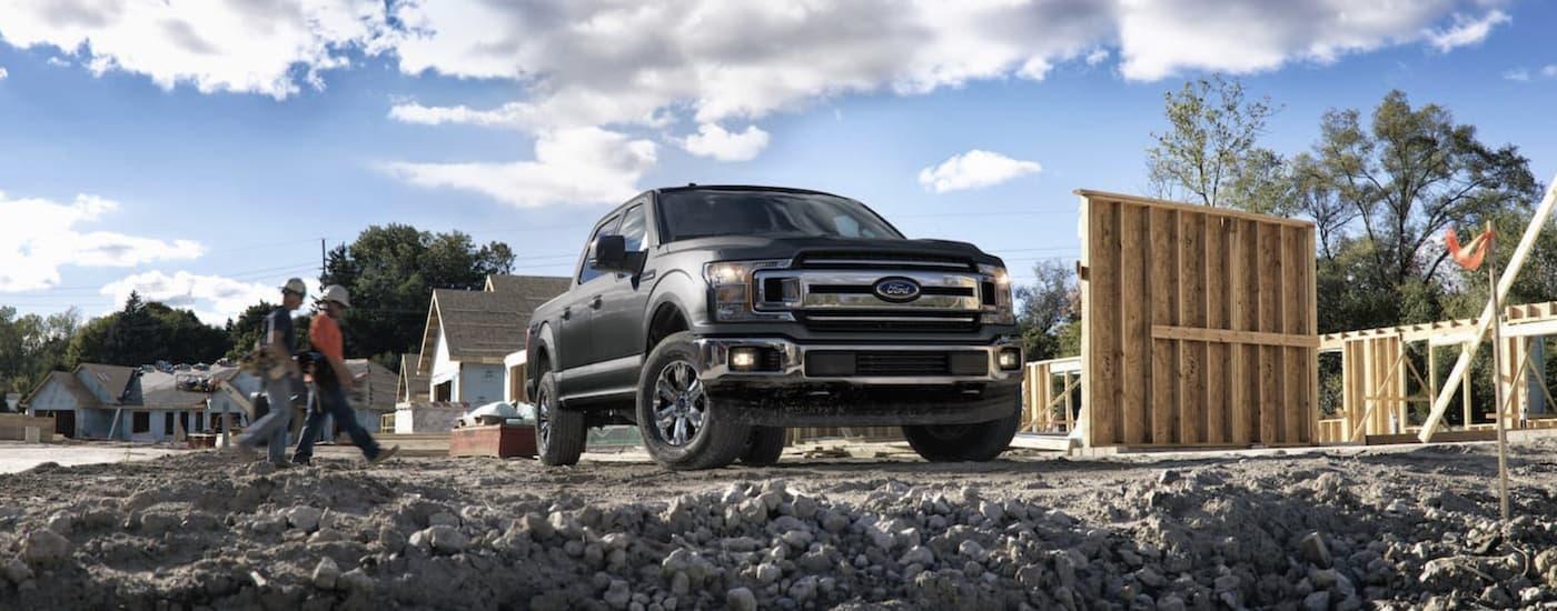 Used Car Dealership - 2018 Ford F-150 Grey.jpeg A grey 2018 Ford F-150 is shown parked at a construction site.