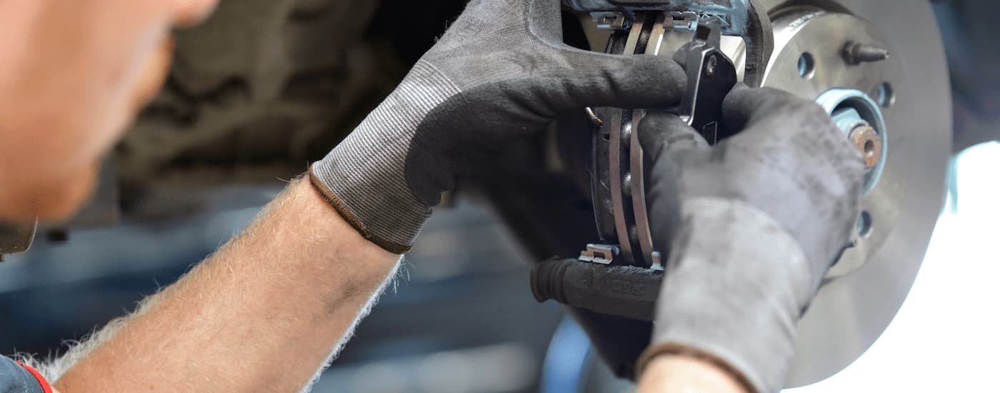 Brake%20Service%20in%20Charlotte%20-%20Brake%20Repair.jpg A close up of a mechanic working on a set of brakes.