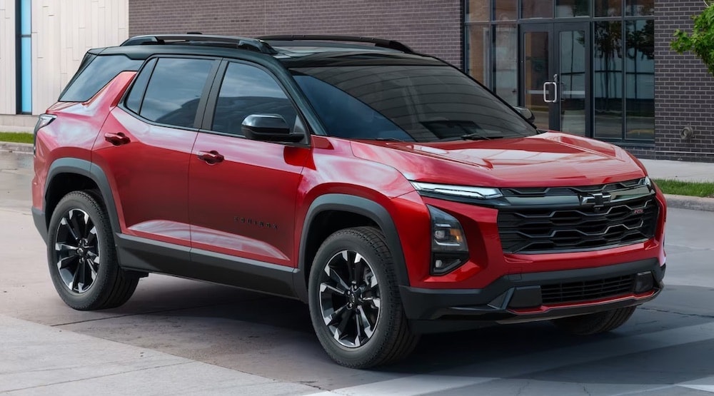 Red 2025 Chevy Equinox RS parked by a curb.