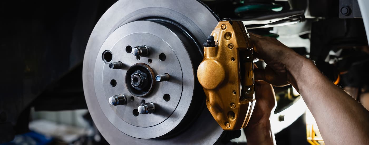 Brake%20Service%20in%20Charlotte%20-%20Rotor%20Caliper.jpg A mechanic is working on a set of brakes during a brake service in Charlotte.