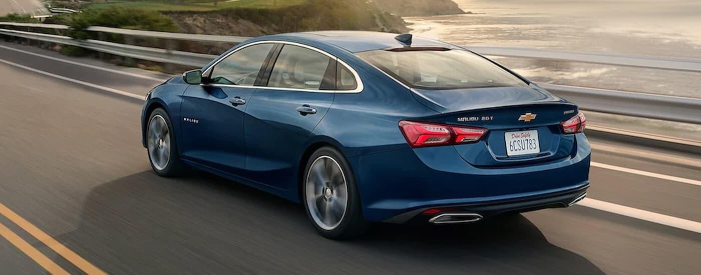 A blue 2022 Chevy Malibu from the rear after leaving a dealer that has used cars for sale near Durham.