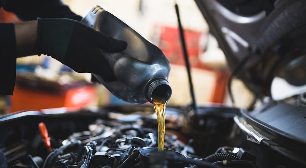 Oil is shown being poured into an engine during an auto service in Atlanta.