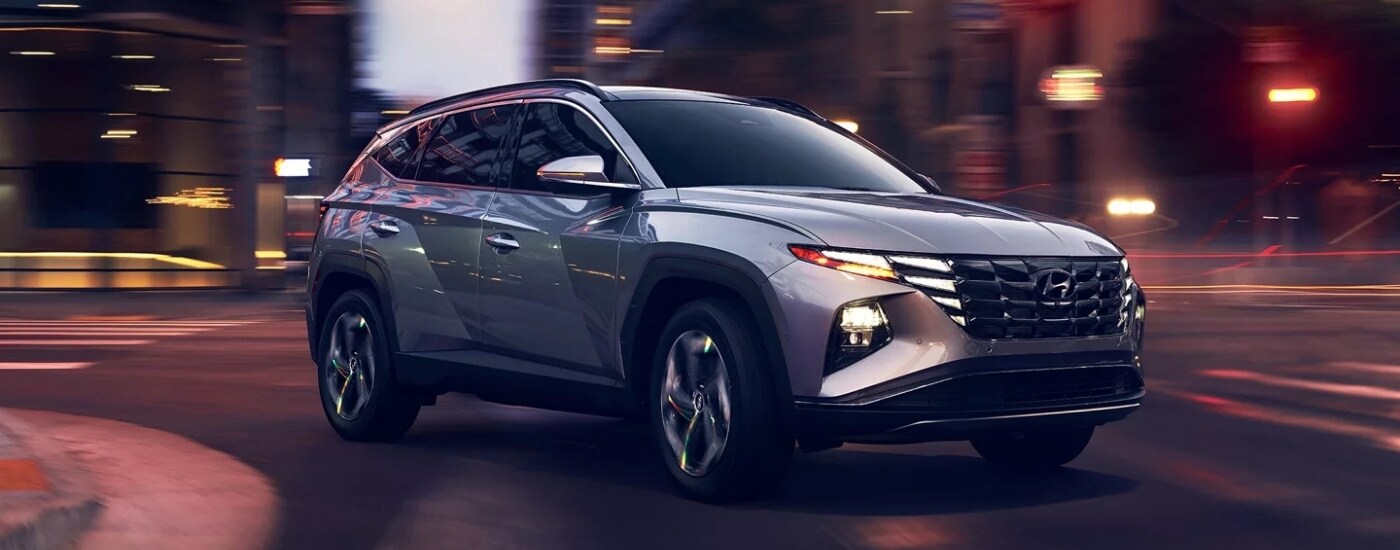 A silver 2021 Hyundai Tuscon is shown from the front at an angle.