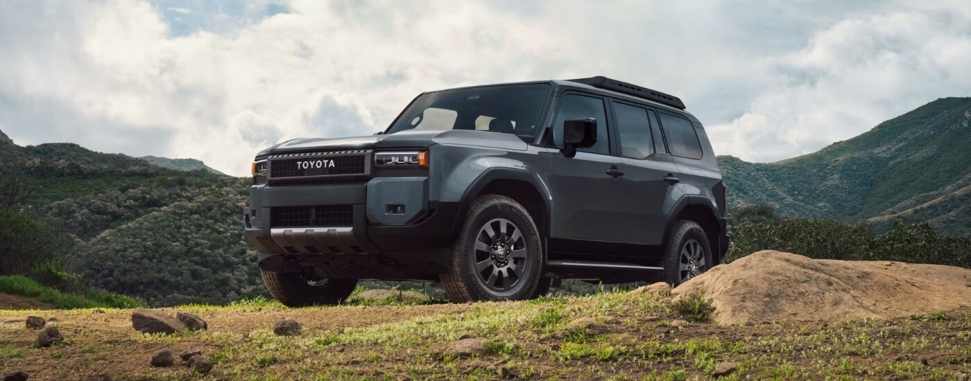 A grey 2024 Toyota Land Cruiser is shown from the front at an angle.