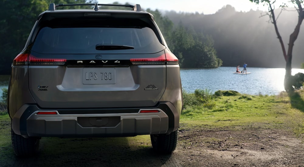 Grey 2026 Toyota RAV4 parked by a lake.