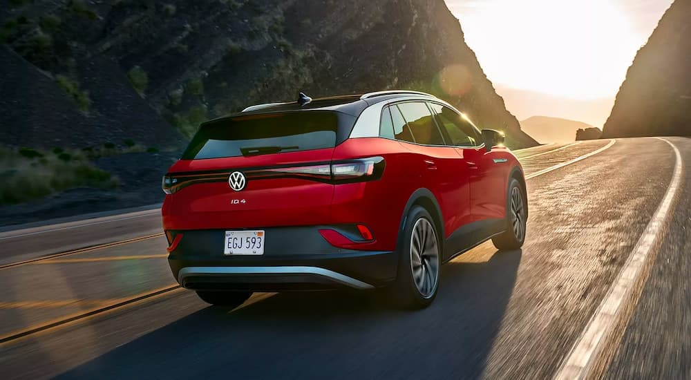 Car Dealership - 2022 Volkswagen ID.4 - Drive.jpg A red 2022 Volkswagen ID.4 is shown rounding a corner.