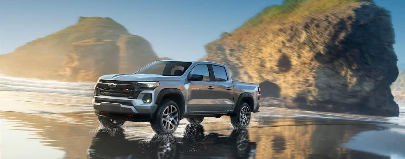 A silver 2025 Chevy Colorado Z71 driving on a beach.