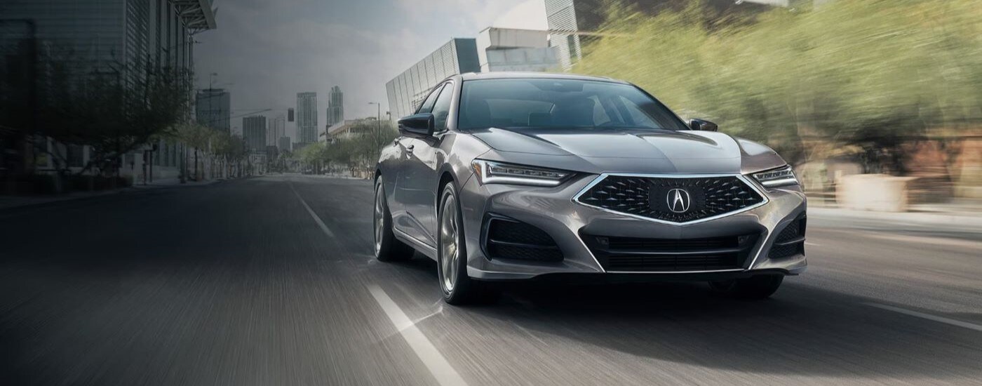2023 Acura TLX - City.jpg A silver 2023 Acura TLX is shown driving on a city street.